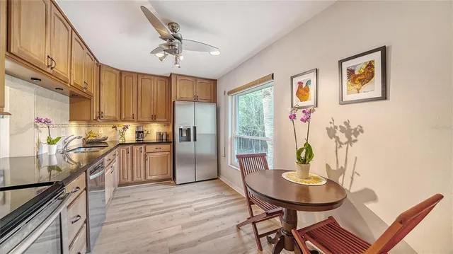 a living room with furniture dining table and a large window