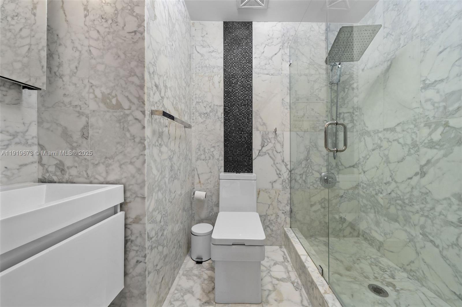 60 Southwest 13th Street, Unit 4606 Miami, FL 33130 - Photo 11 of 28 a bathroom with a sink a toilet and shower