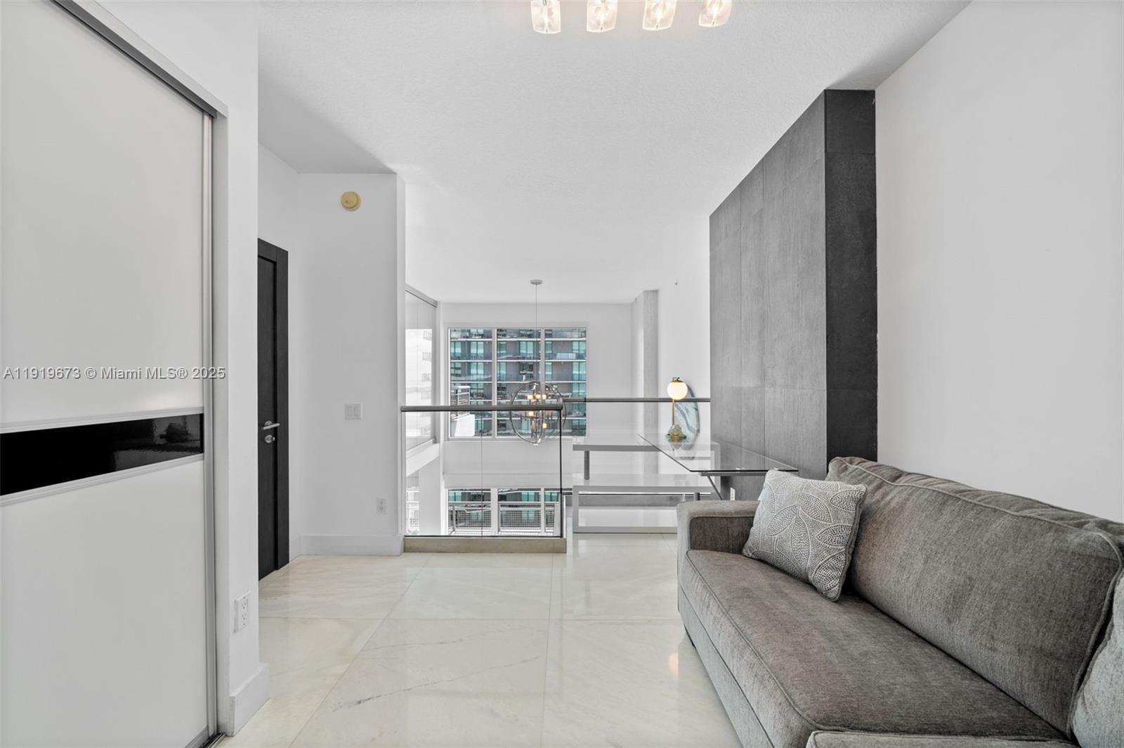 60 Southwest 13th Street, Unit 4606 Miami, FL 33130 - Photo 14 of 28 a living room with furniture and a table