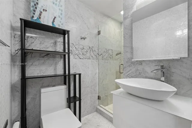 a bathroom with a toilet sink and shower