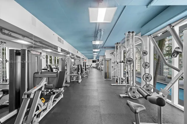 a view of a room with lots of gym equipment