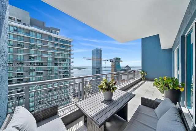 a living room with furniture and flowers