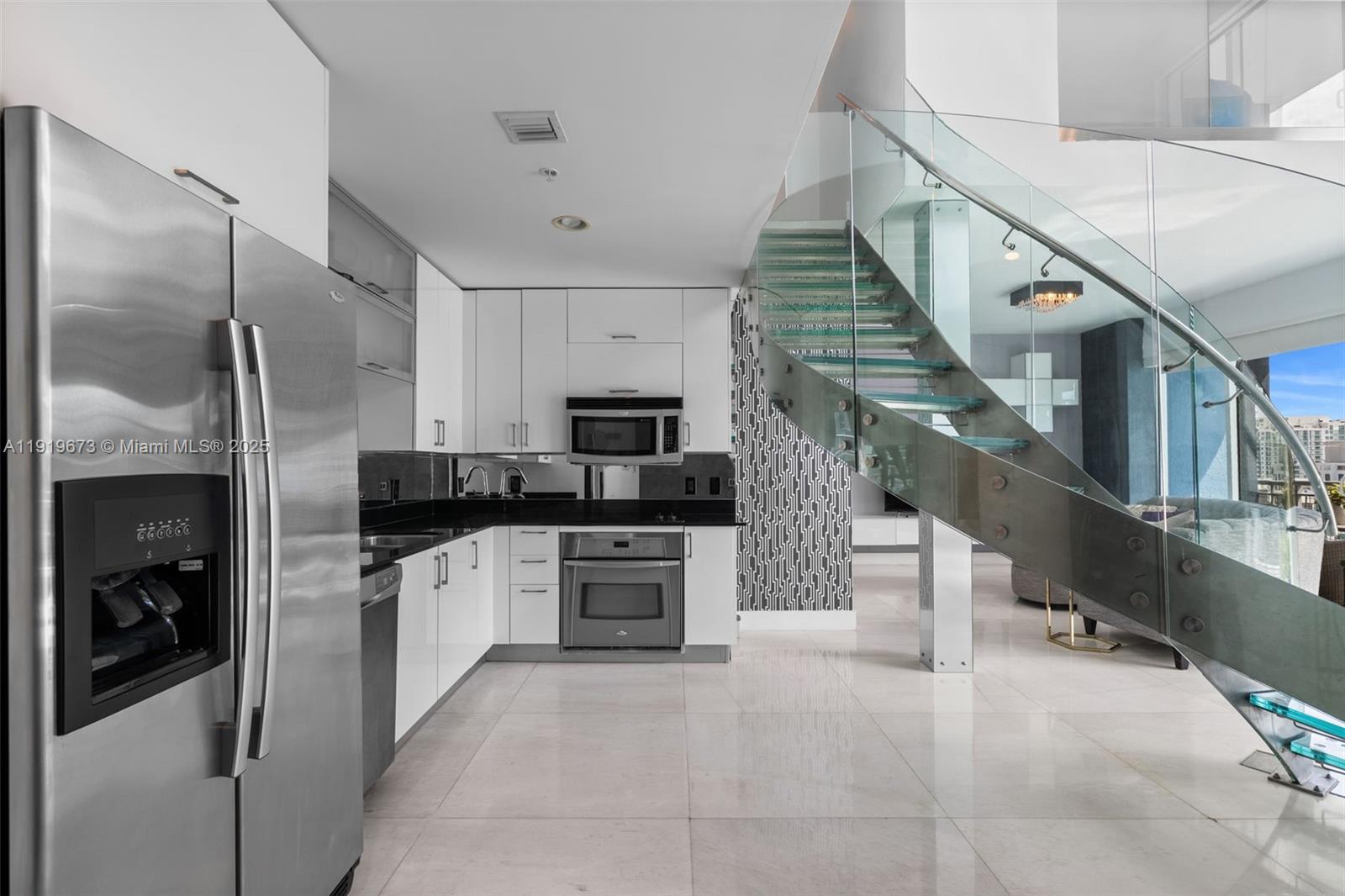 60 Southwest 13th Street, Unit 4606 Miami, FL 33130 - Photo 7 of 28 a kitchen with stainless steel appliances granite countertop a refrigerator a stove and a sink