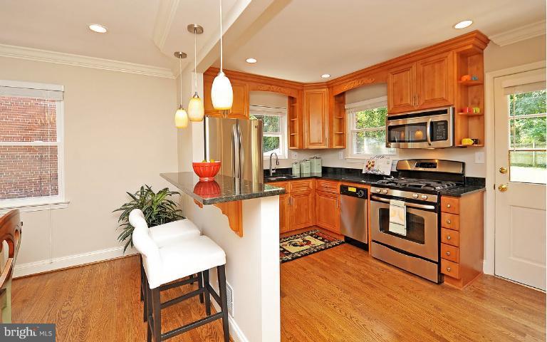 716 West Glebe Road Alexandria, VA 22305 - Photo 21 of 27 a kitchen with stainless steel appliances granite countertop a stove a sink and a refrigerator
