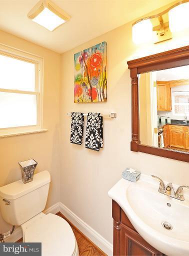 716 West Glebe Road Alexandria, VA 22305 - Photo 24 of 27 a bathroom with a toilet a sink and a large mirror