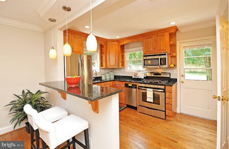 716 West Glebe Road Alexandria, VA 22305 - Photo 7 of 27 a kitchen with stainless steel appliances granite countertop a stove a sink dishwasher and a refrigerator with wooden floor