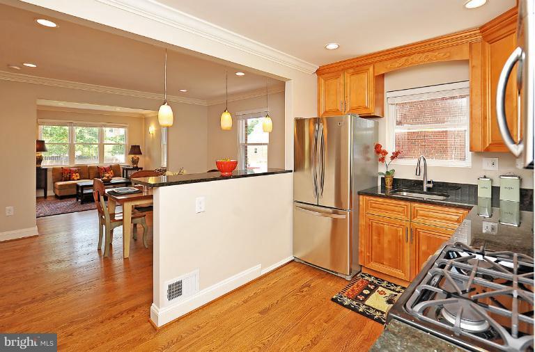 716 West Glebe Road Alexandria, VA 22305 - Photo 8 of 27 a kitchen with stainless steel appliances granite countertop a refrigerator a stove and a sink with wooden floor