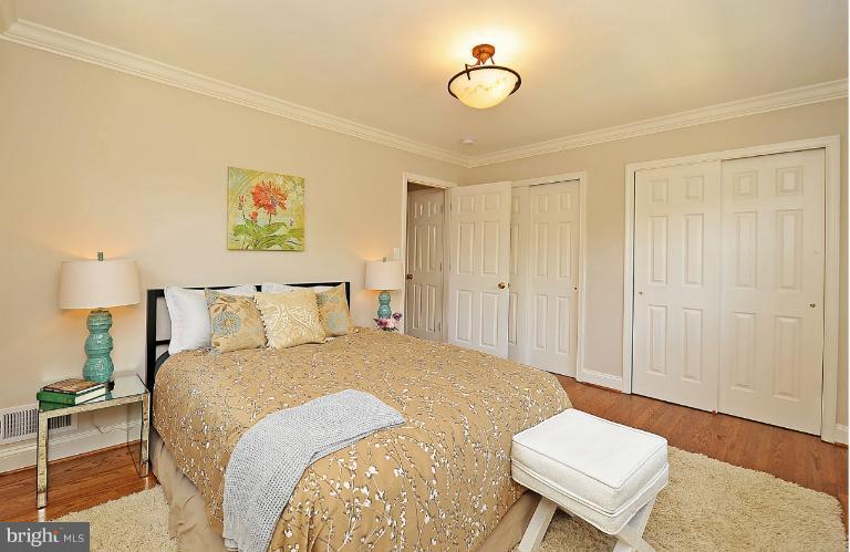 716 West Glebe Road Alexandria, VA 22305 - Photo 9 of 27 a spacious bedroom with a bed and a table in it