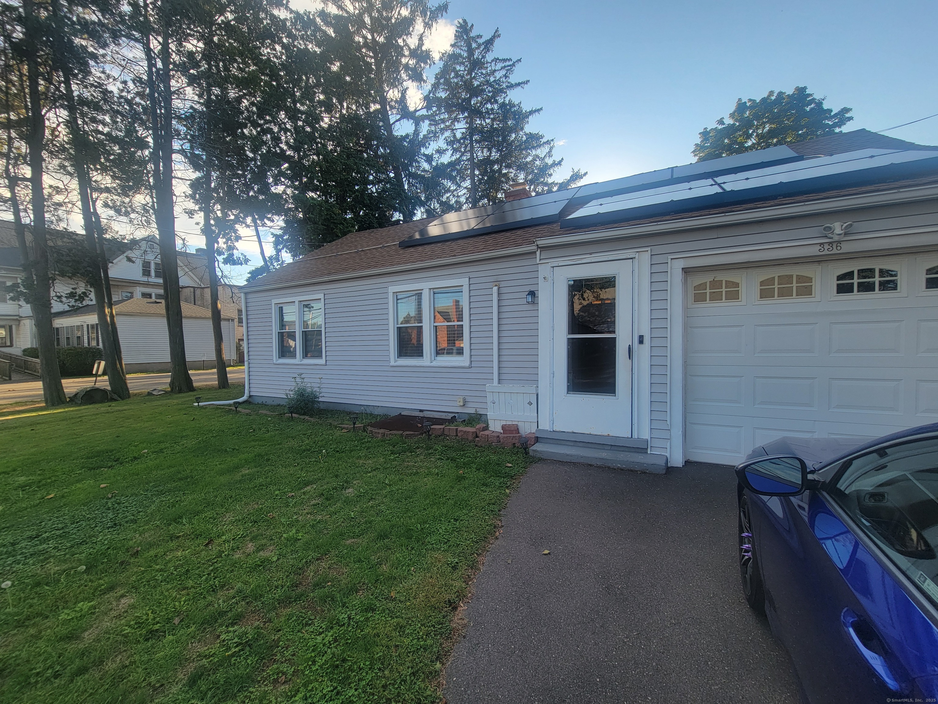 a view of house with backyard and outdoor seating