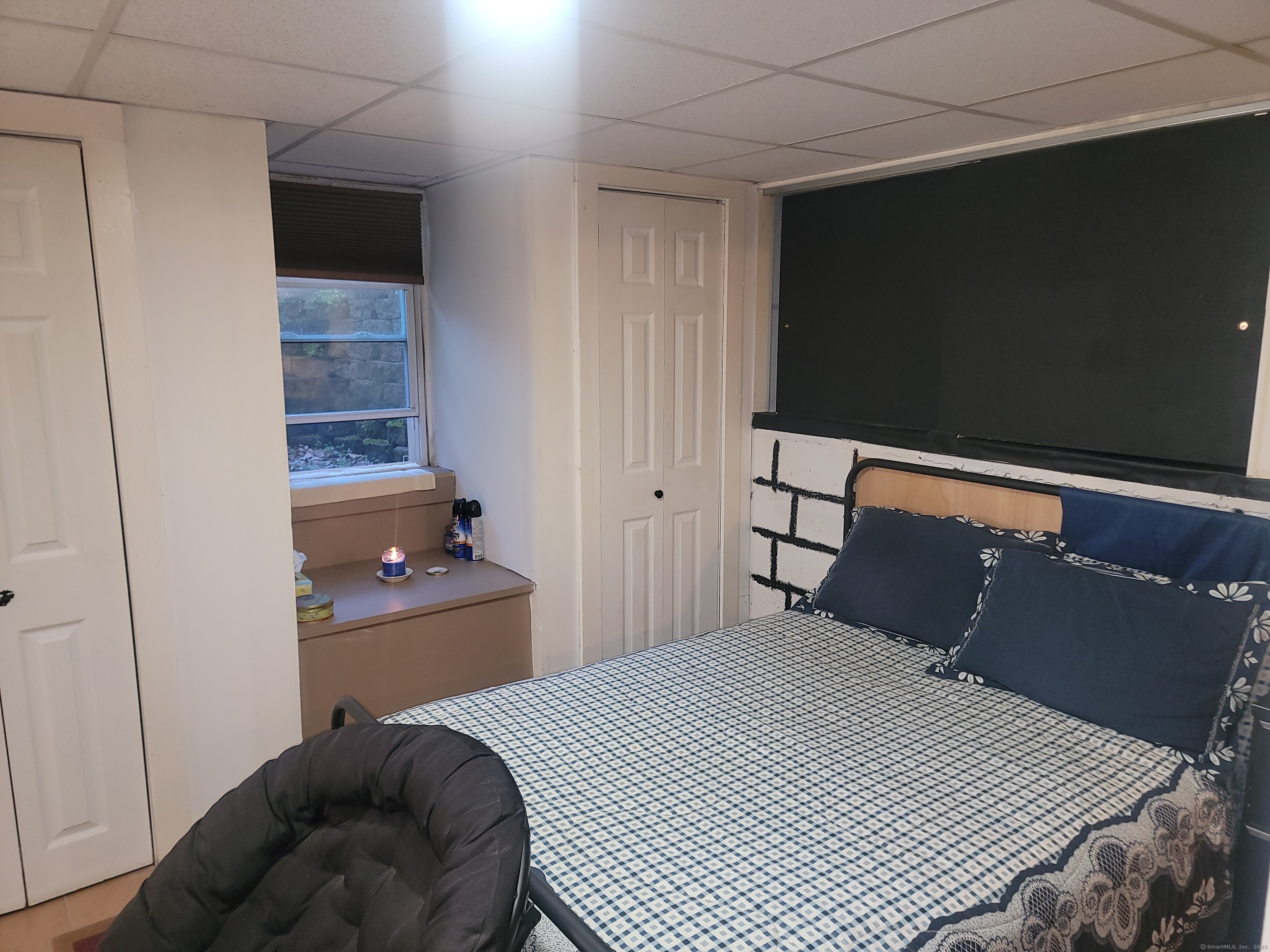 336 Circular Avenue Hamden, CT 06514 - Photo 17 of 21 a bedroom with a bed and a flat tv screen