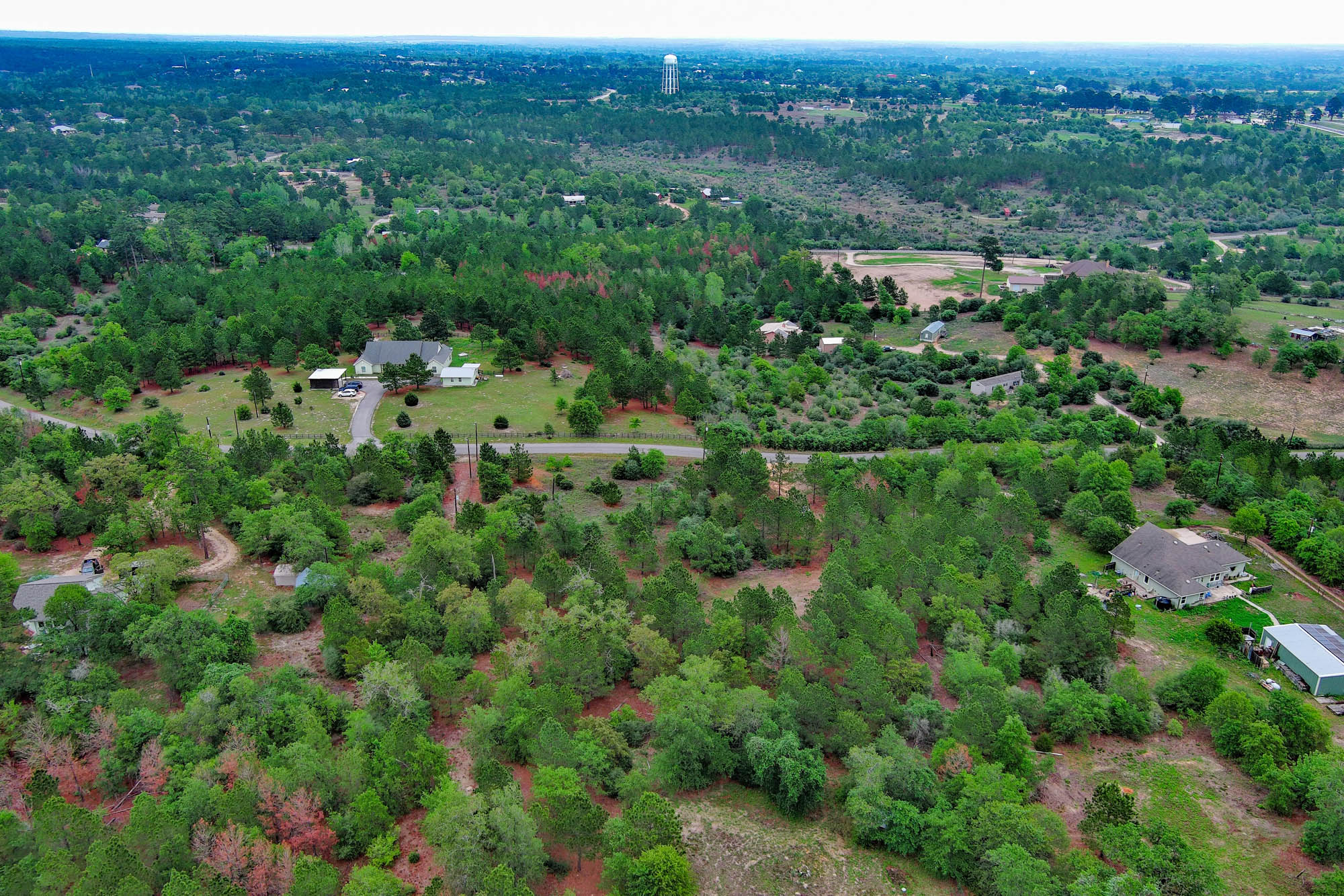 172 Kelley Road East Bastrop, TX 78602 - Photo 7 of 26 an aerial view of a house with a lush green forest
