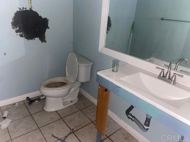 5676 Dehesa Road El Cajon, CA 92019 - Photo 2 of 23 a bathroom with a toilet sink and mirror
