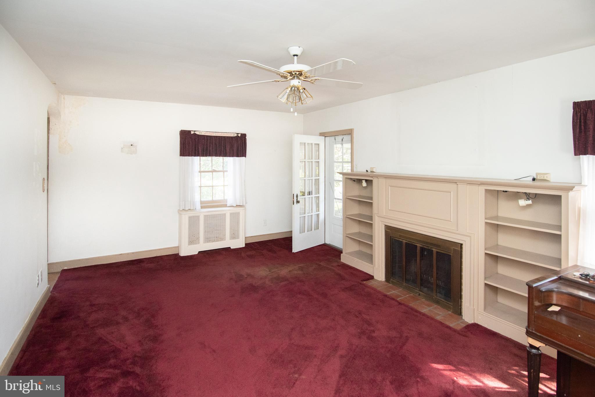 800 Forrest Street Lansdale, PA 19446 - Photo 6 of 42 an empty room with windows and fireplace