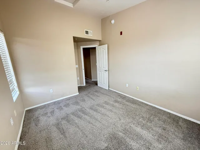 a view of empty room with kitchen