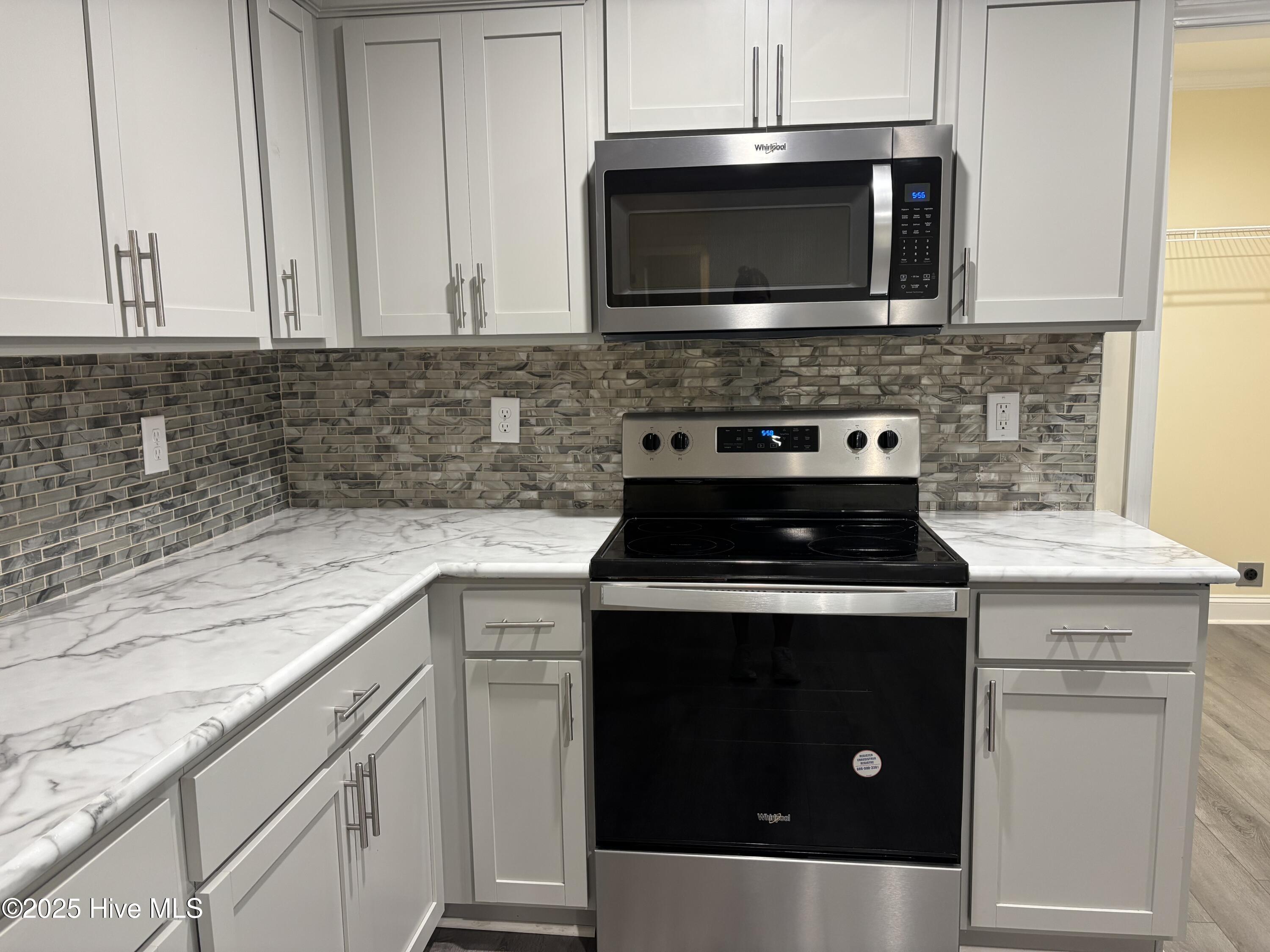 64 High Orchard Road Whiteville, NC 28472 - Photo 16 of 33 Nice backsplash, stainless appliances, and trendy countertops.
