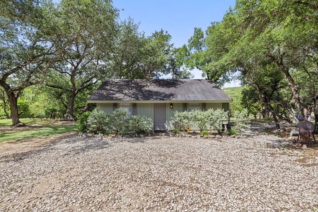 23644 Nameless Road Leander, TX 78641 - Photo 22 of 40 A charming cottage is nestled amidst mature trees, offering a private, tranquil retreat.