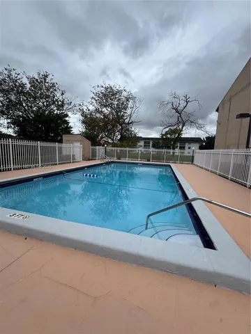 a view of a swimming pool with an outdoor seating