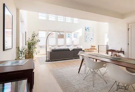 a living room with a table and chairs
