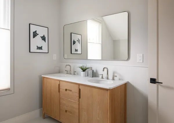 a bathroom with a double vanity sink and a mirror