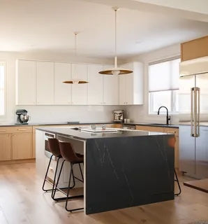 a kitchen with a sink cabinets and window