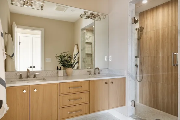 a bathroom with a granite countertop sink mirror and double