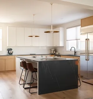 a kitchen with a sink cabinets and window