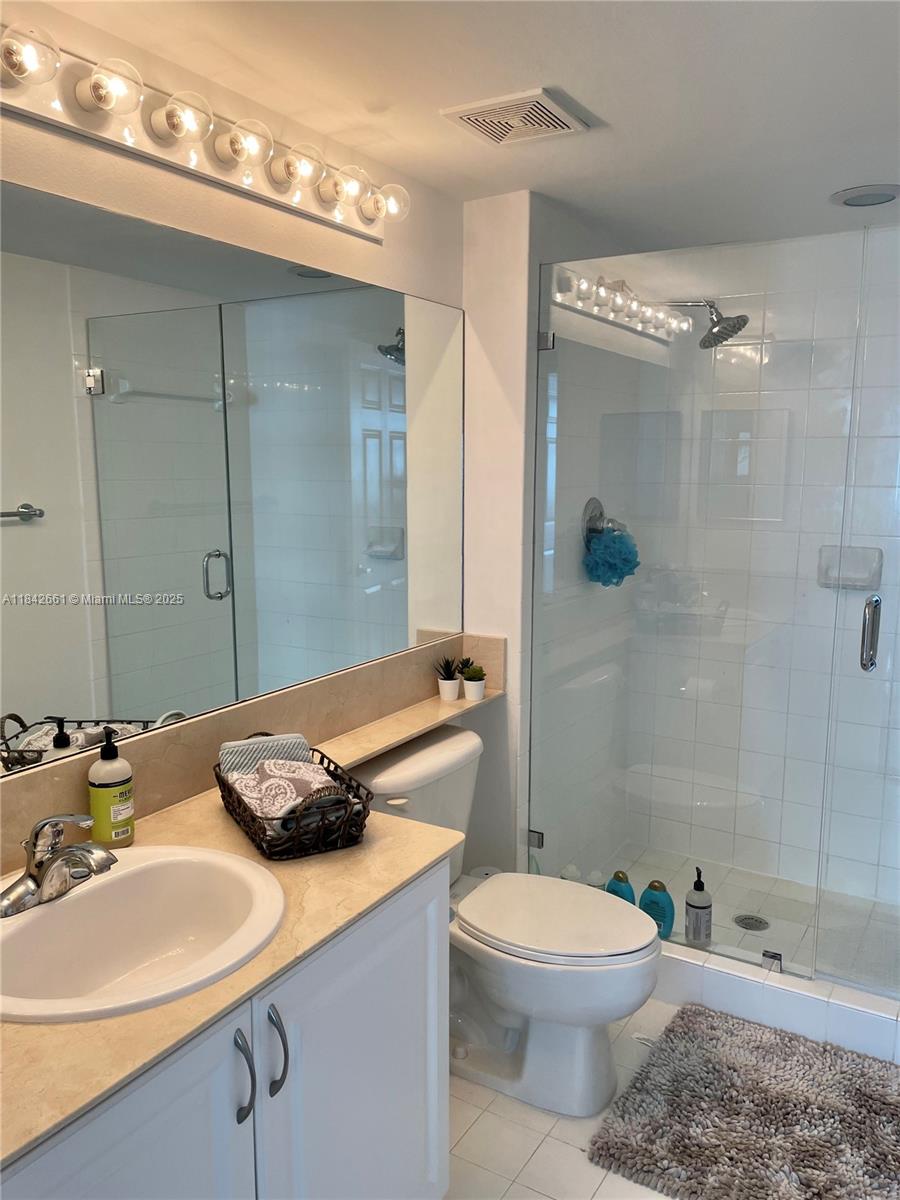 1155 Brickell Bay Drive, Unit 2802 Miami, FL 33131 - Photo 23 of 43 a bathroom with a sink a toilet and shower