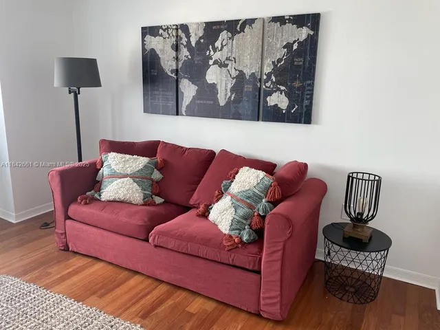 a living room with furniture and a lamp