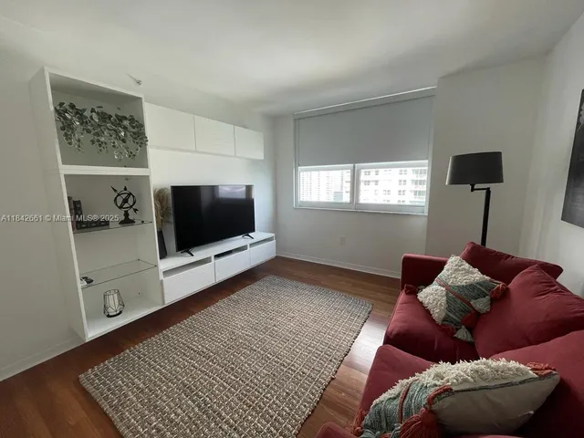 a living room with a couch and a flat screen tv