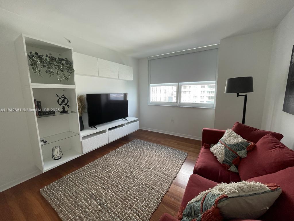 1155 Brickell Bay Drive, Unit 2802 Miami, FL 33131 - Photo 26 of 43 a living room with a couch and a flat screen tv