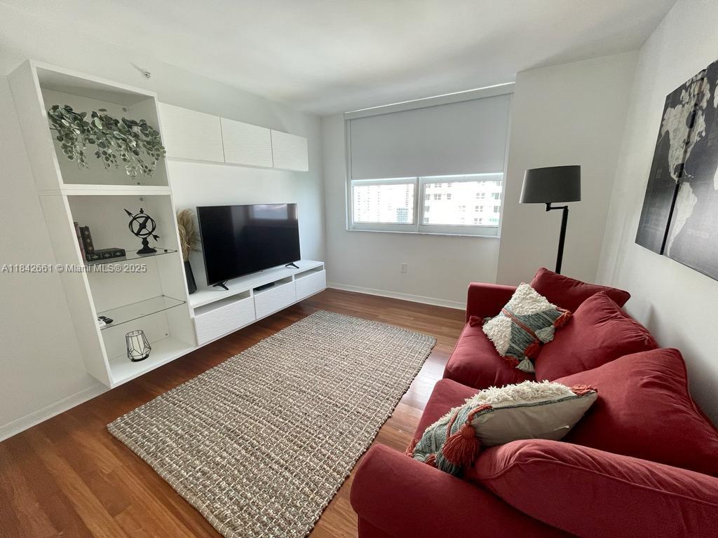 1155 Brickell Bay Drive, Unit 2802 Miami, FL 33131 - Photo 27 of 43 a living room with a bed and a flat screen tv