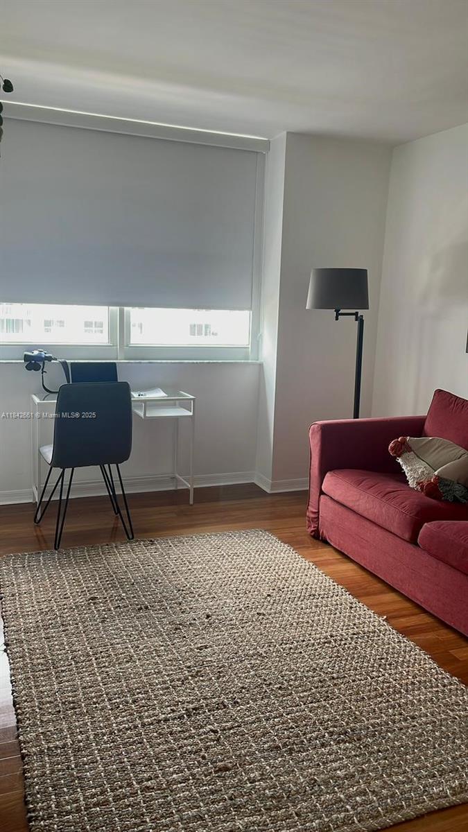 1155 Brickell Bay Drive, Unit 2802 Miami, FL 33131 - Photo 29 of 43 a bedroom with a bed and a chair