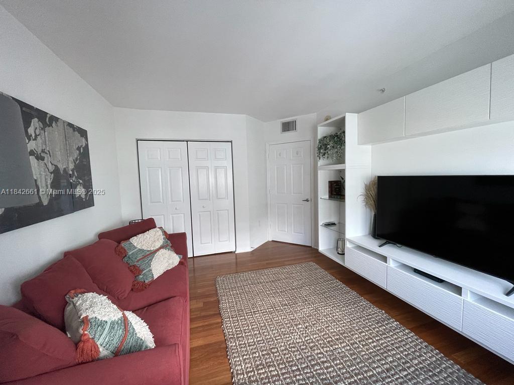 1155 Brickell Bay Drive, Unit 2802 Miami, FL 33131 - Photo 30 of 43 a living room with furniture and a flat screen tv