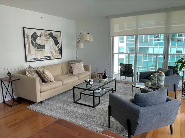 a living room with furniture and a large window