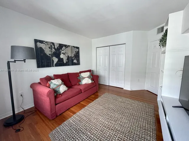a living room with furniture and a rug