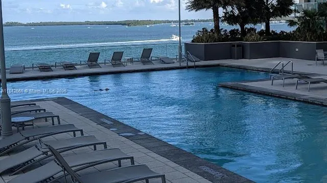 a view of a terrace with wooden floor and lake view