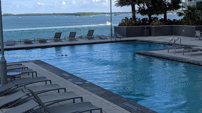1155 Brickell Bay Drive, Unit 2802 Miami, FL 33131 - Photo 38 of 43 a view of a terrace with wooden floor and lake view