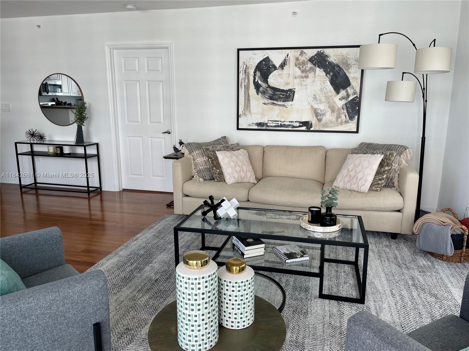 1155 Brickell Bay Drive, Unit 2802 Miami, FL 33131 - Photo 4 of 43 a living room with furniture and a wooden floor