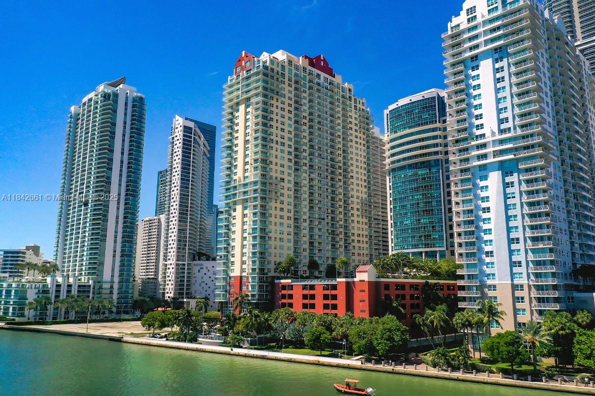 1155 Brickell Bay Drive, Unit 2802 Miami, FL 33131 - Photo 43 of 43 a front view of a residential apartment building with a yard and plants