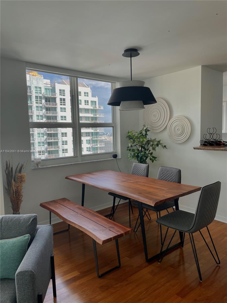 1155 Brickell Bay Drive, Unit 2802 Miami, FL 33131 - Photo 7 of 43 a dining room with furniture and window