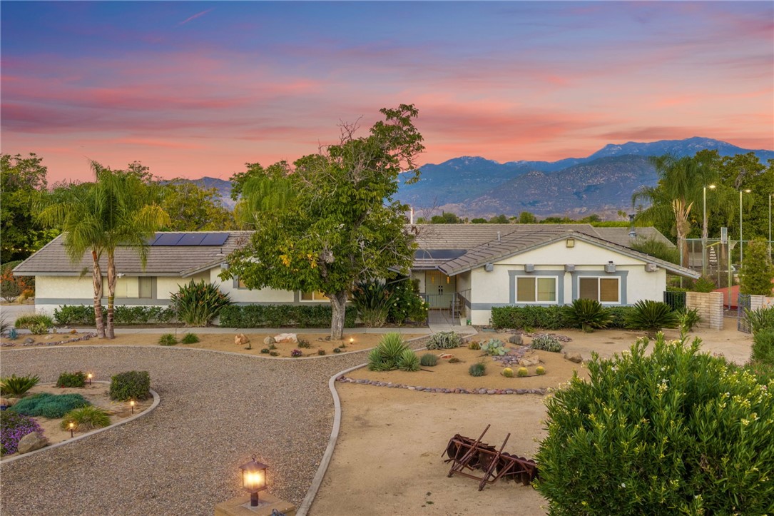 26440 Old Agency Road Hemet, CA 92544 - Photo 2 of 74 a view of a white house with a yard and a large tree