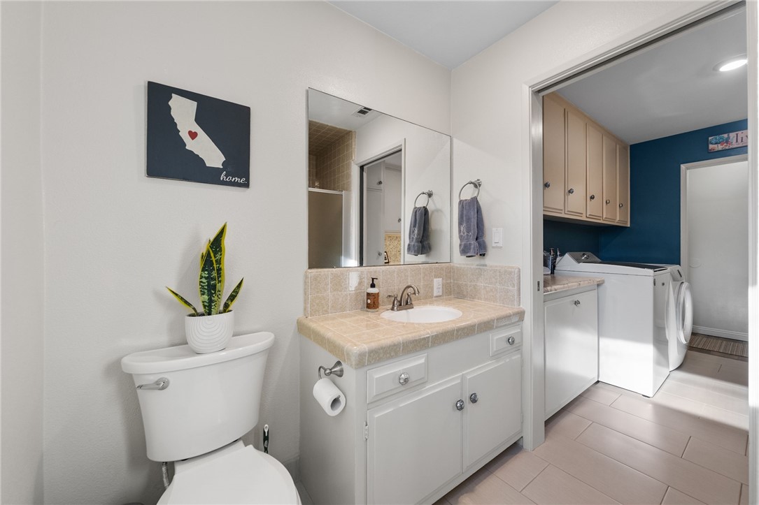 26440 Old Agency Road Hemet, CA 92544 - Photo 26 of 74 a bathroom with a toilet sink and mirror