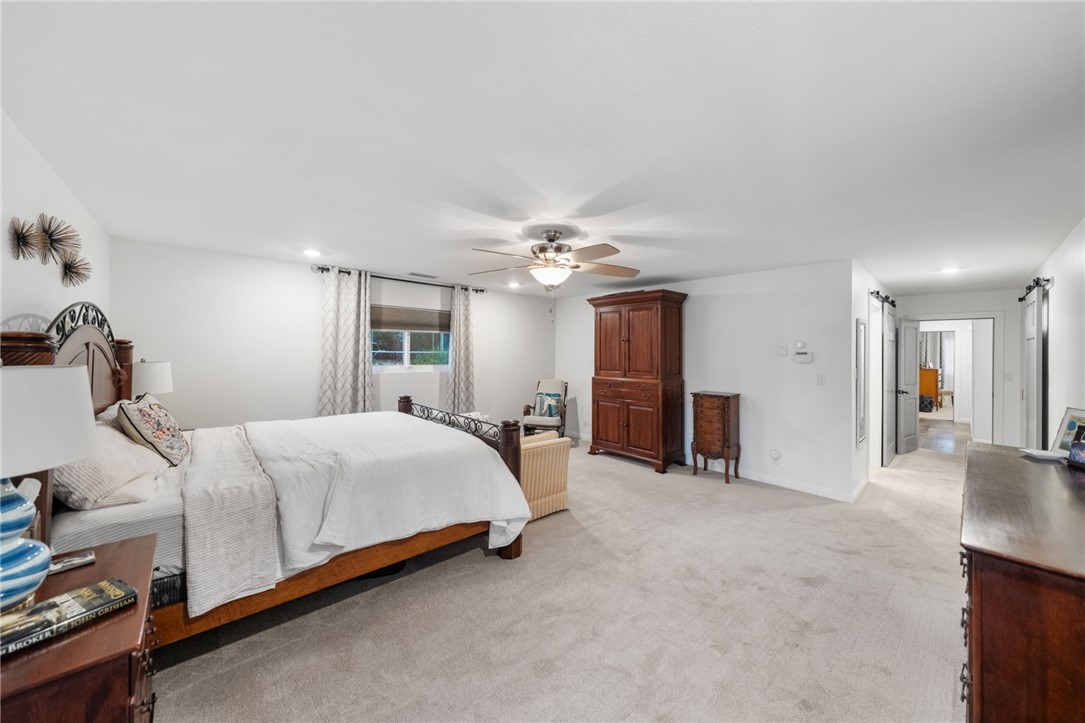 26440 Old Agency Road Hemet, CA 92544 - Photo 30 of 74 a bed room with a bed and a chandelier