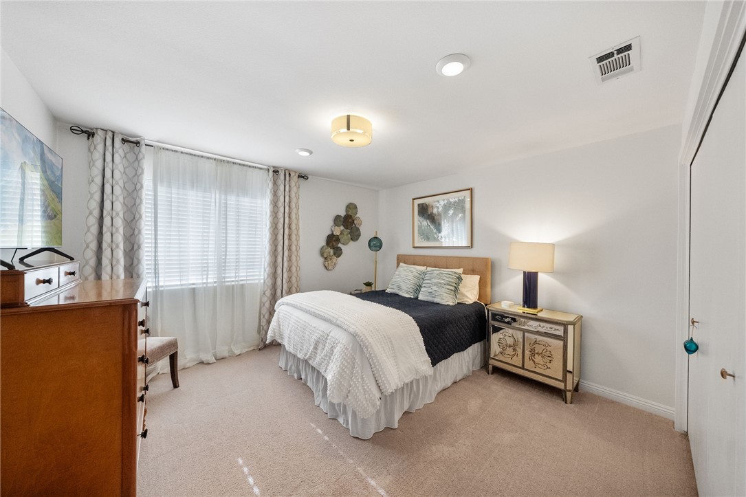 26440 Old Agency Road Hemet, CA 92544 - Photo 38 of 74 a spacious bedroom with a bed and a dresser