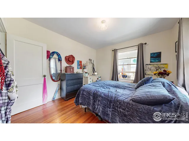 a kitchen with a refrigerator and white cabinets