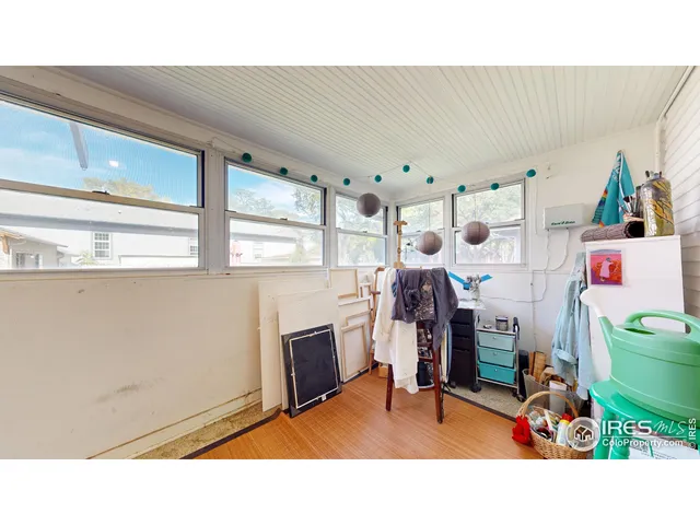 a living room with furniture and wall paintings