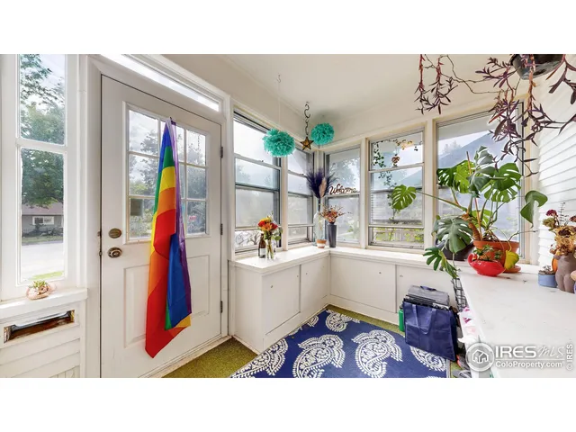 a living room with furniture a fireplace and a large window