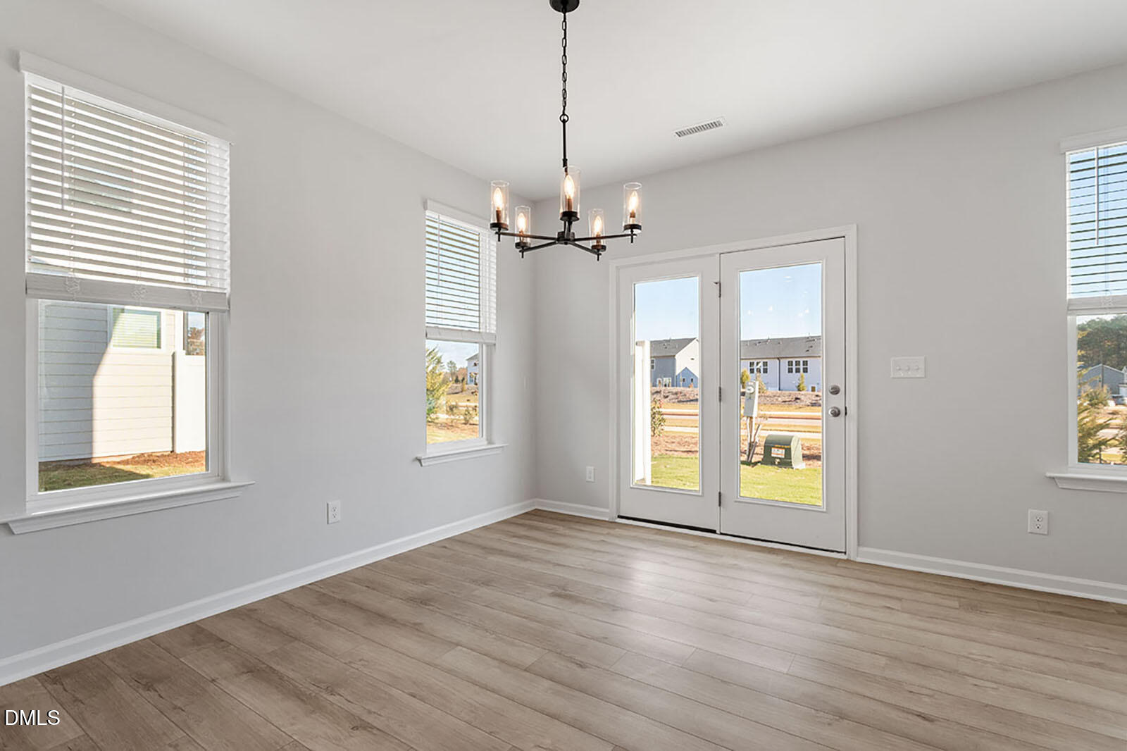 931 Westerland Way, Unit 74 Durham, NC 27703 - Photo 9 of 33 a view of an empty room with a window and wooden floor