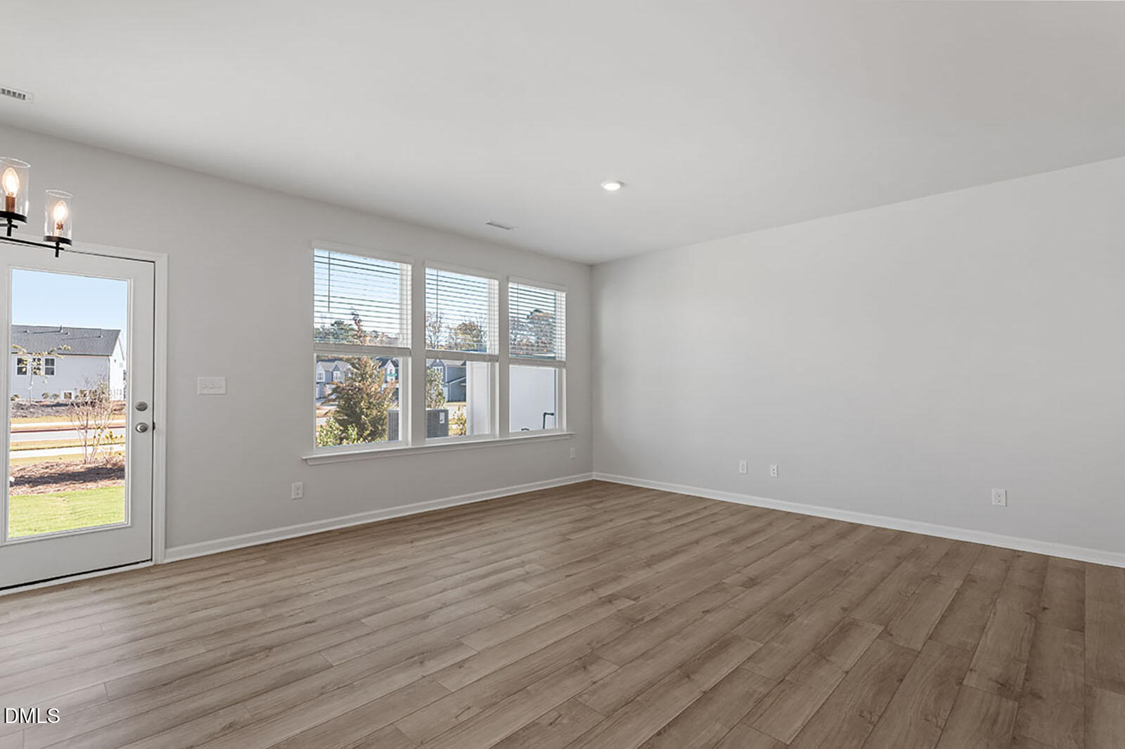 931 Westerland Way, Unit 74 Durham, NC 27703 - Photo 10 of 33 an empty room with wooden floor and windows