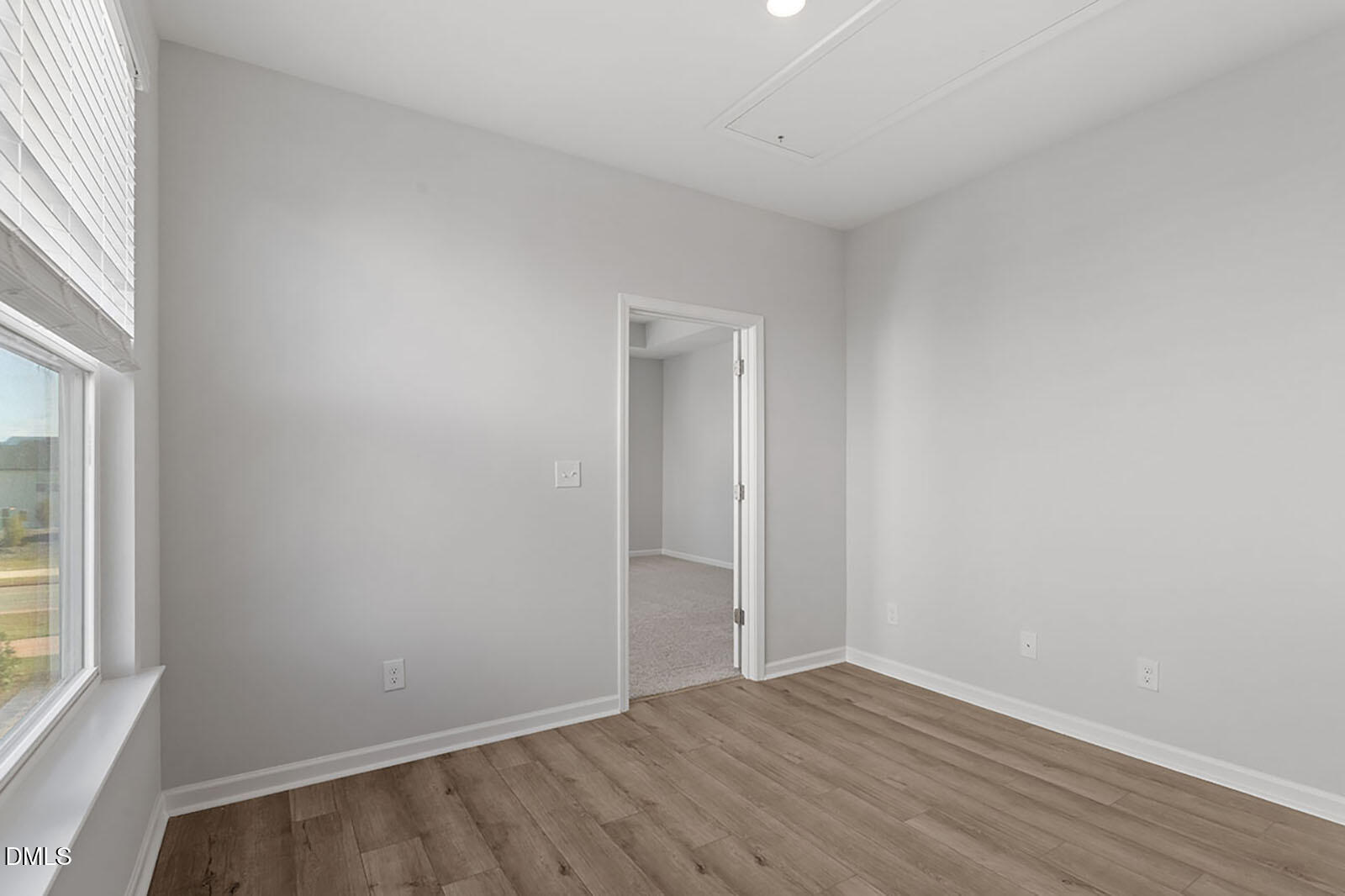 931 Westerland Way, Unit 74 Durham, NC 27703 - Photo 14 of 33 an empty room with wooden floor and windows
